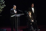 Michael Barker accepts the award as Marcie Bloom and Tom Bernard look on.