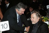 Honoree DeNiro spends a moment at the table of his old friend, actor Harvey Keitel. (Photo by Evan Agostini/Getty Images)