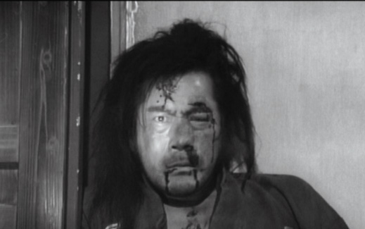 ONE -EYED JACK: Mifune's one good eye is visible in a patch of light after he is beaten and locked up in Kurosawa's Yojimbo (1961). - photo courtesy Criterion Collection